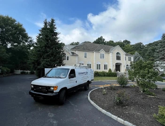 New Franklin Power Washing technician performing thorough gutter cleaning service in New Franklin