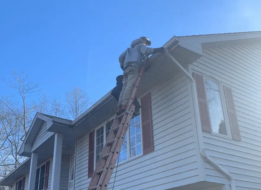 Gutter cleaning and maintenance being performed by New Franklin Power Washing in New Franklin